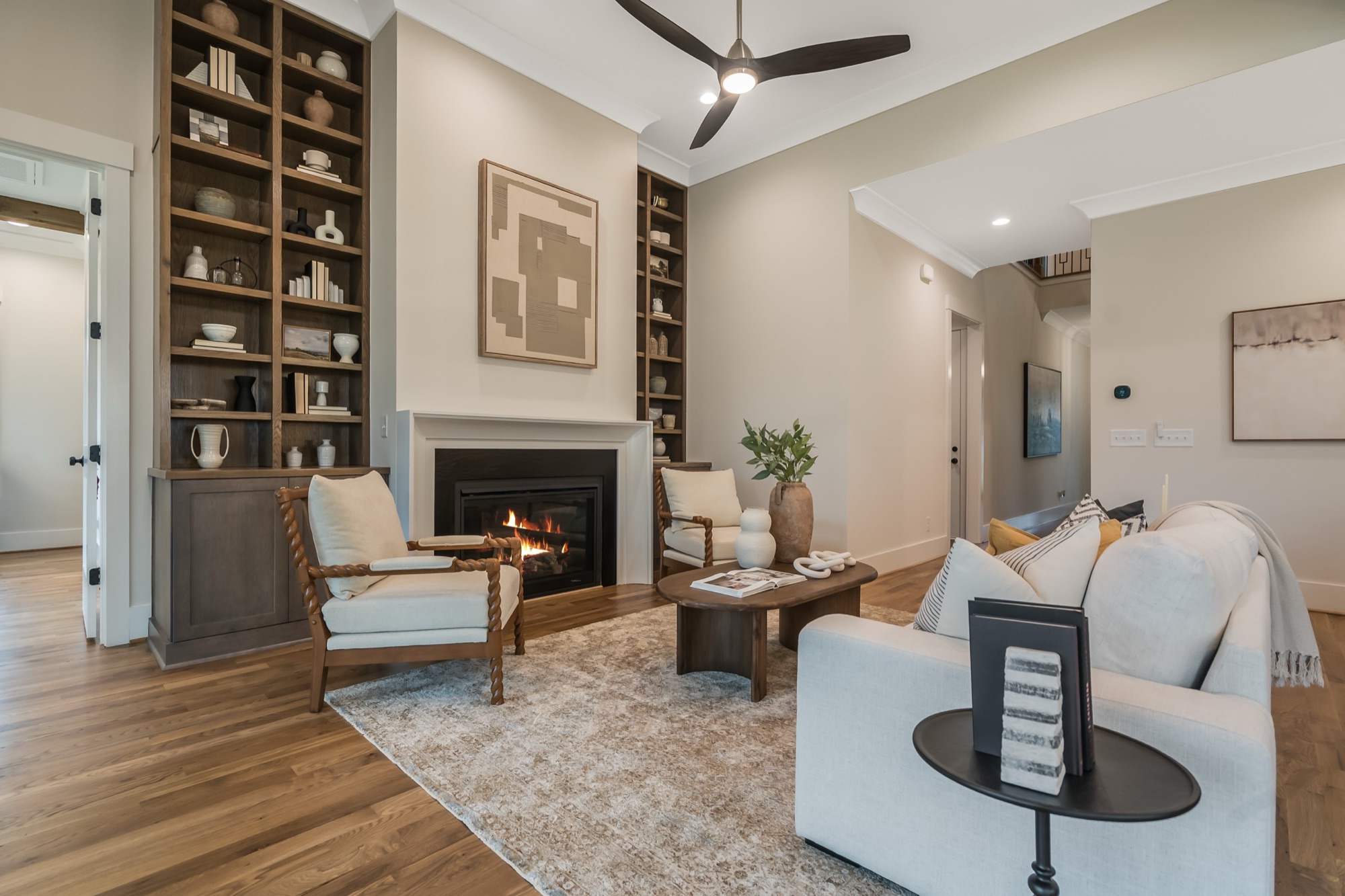 Family room with lit gas fireplace and built-in shelving