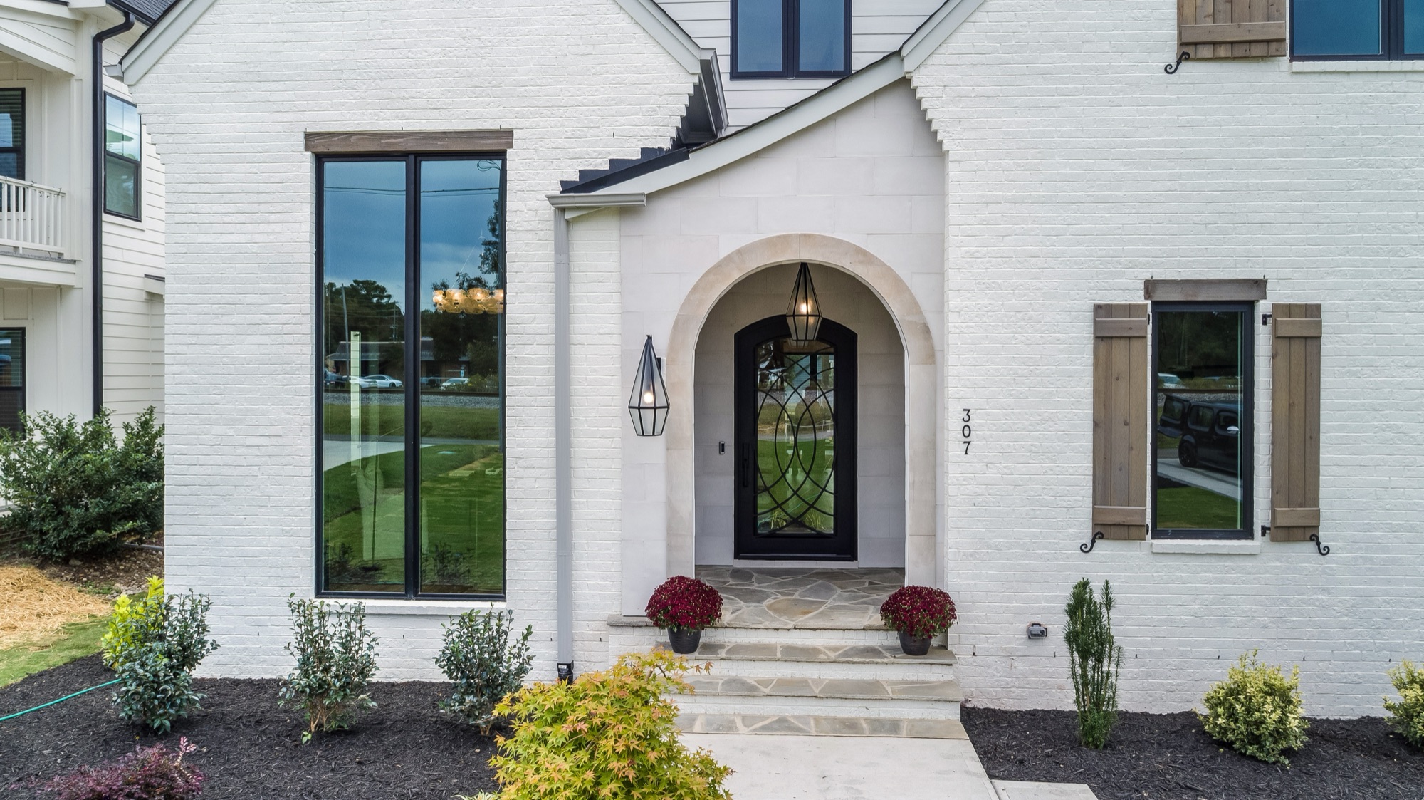 Arched brick entry on a Gemstone custom home