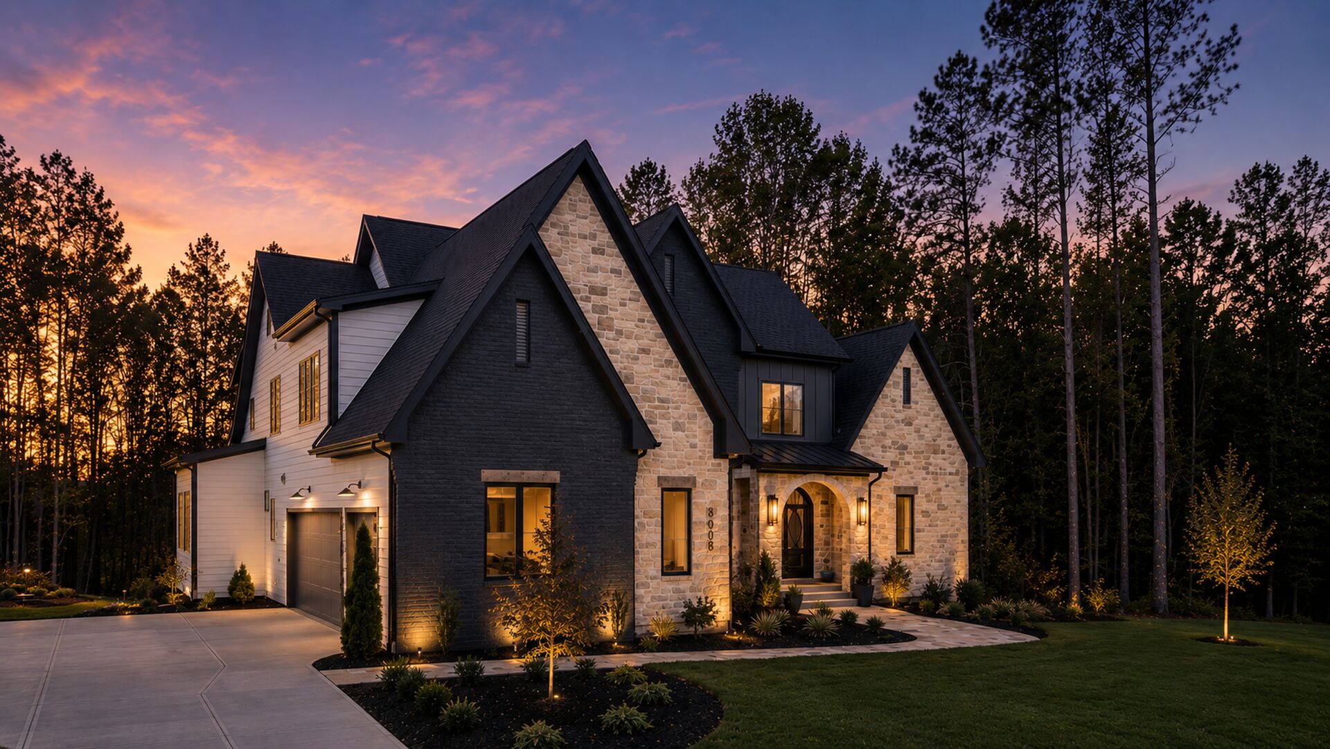 A Gemstone custom stone-and-brick home lit at twilight in NC's Research Triangle