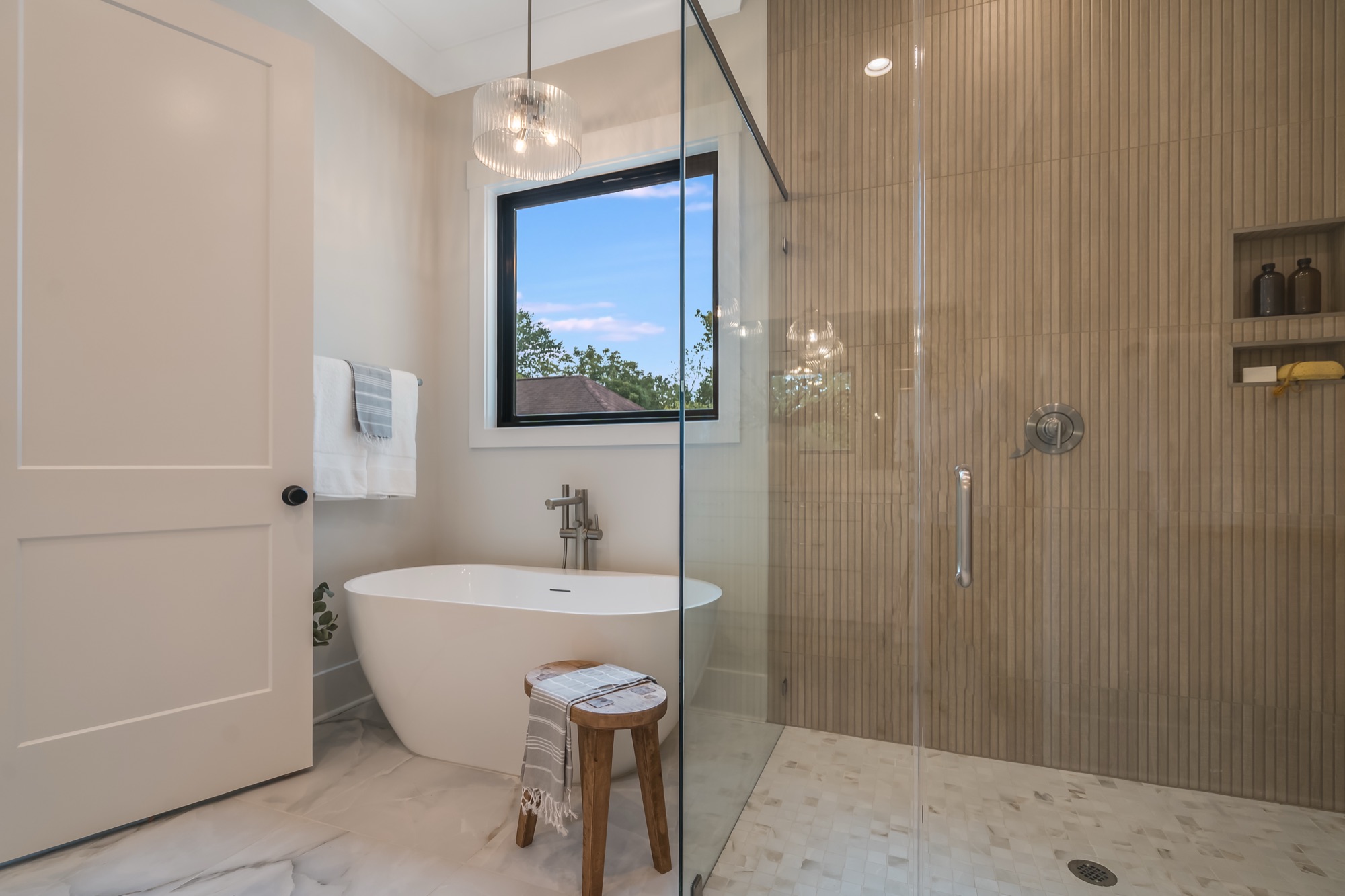 Master bath with freestanding tub and natural light
