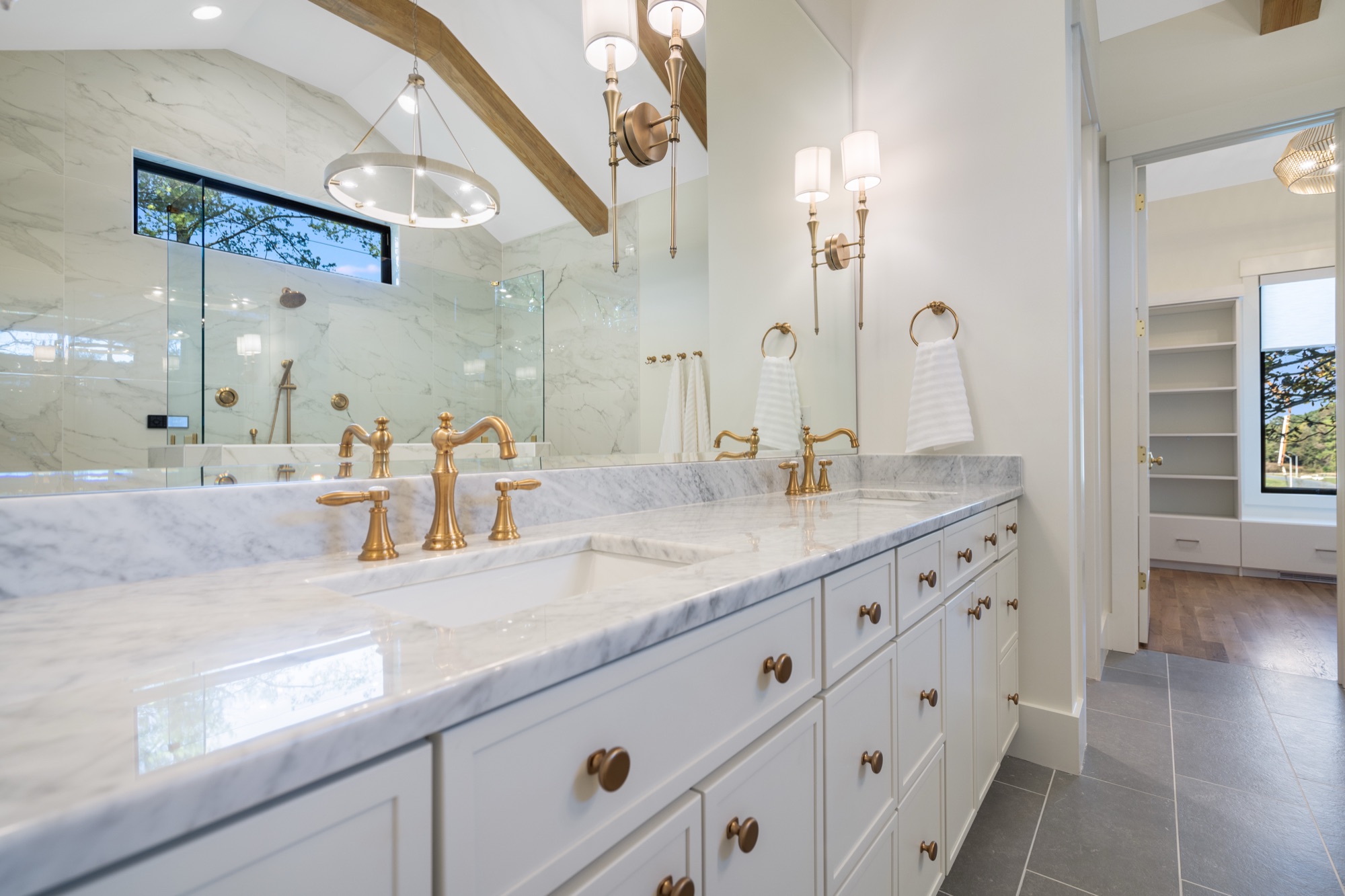 Brass faucets on marble vanity
