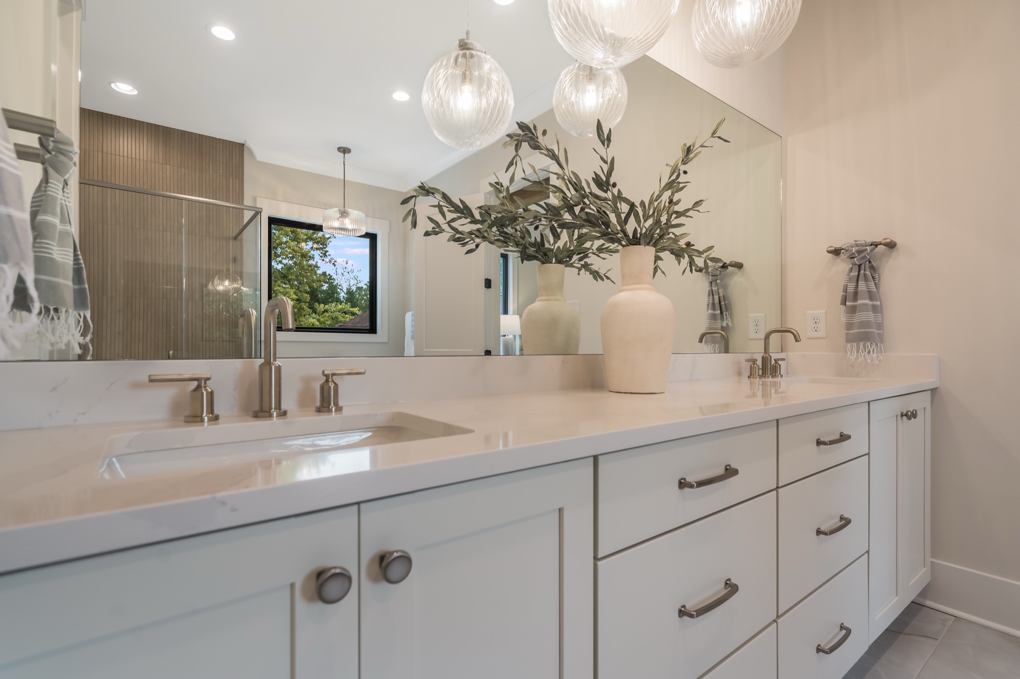 Brushed nickel hardware on white vanity
