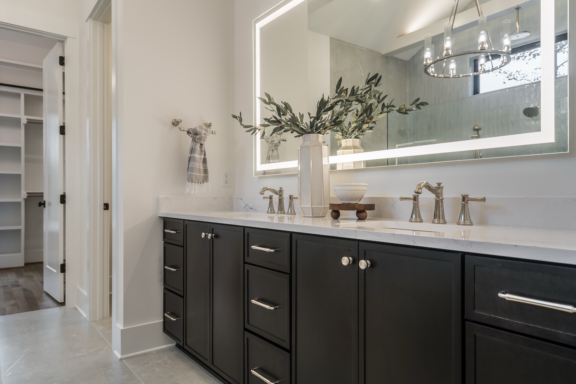 Polished nickel faucet and hardware on white vanity