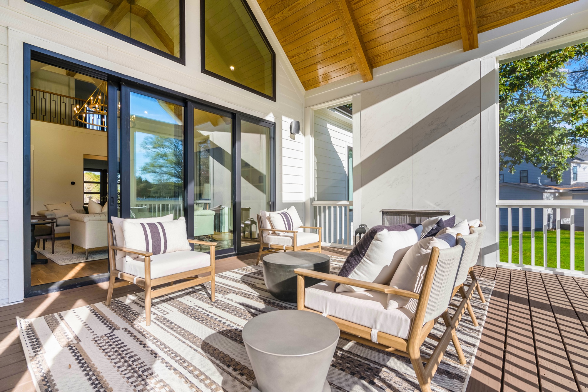 Screened porch with vaulted wood ceiling, the kind of room that survives the build process