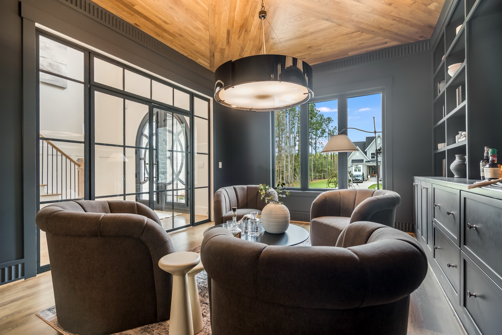 Lounge with steel-frame doors and drum pendant