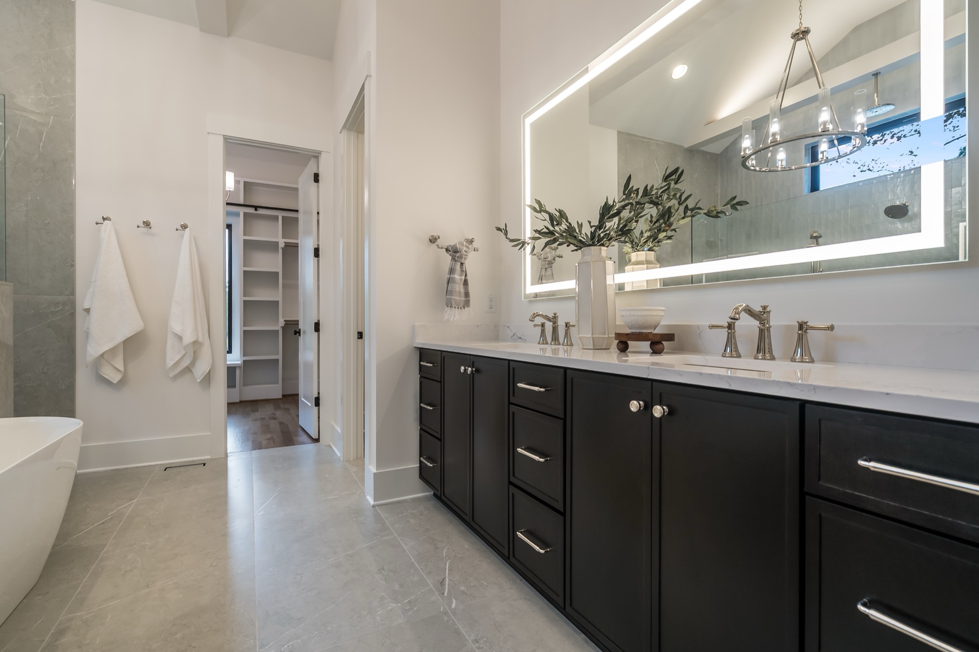 Master bathroom with lighted vanity and styled details