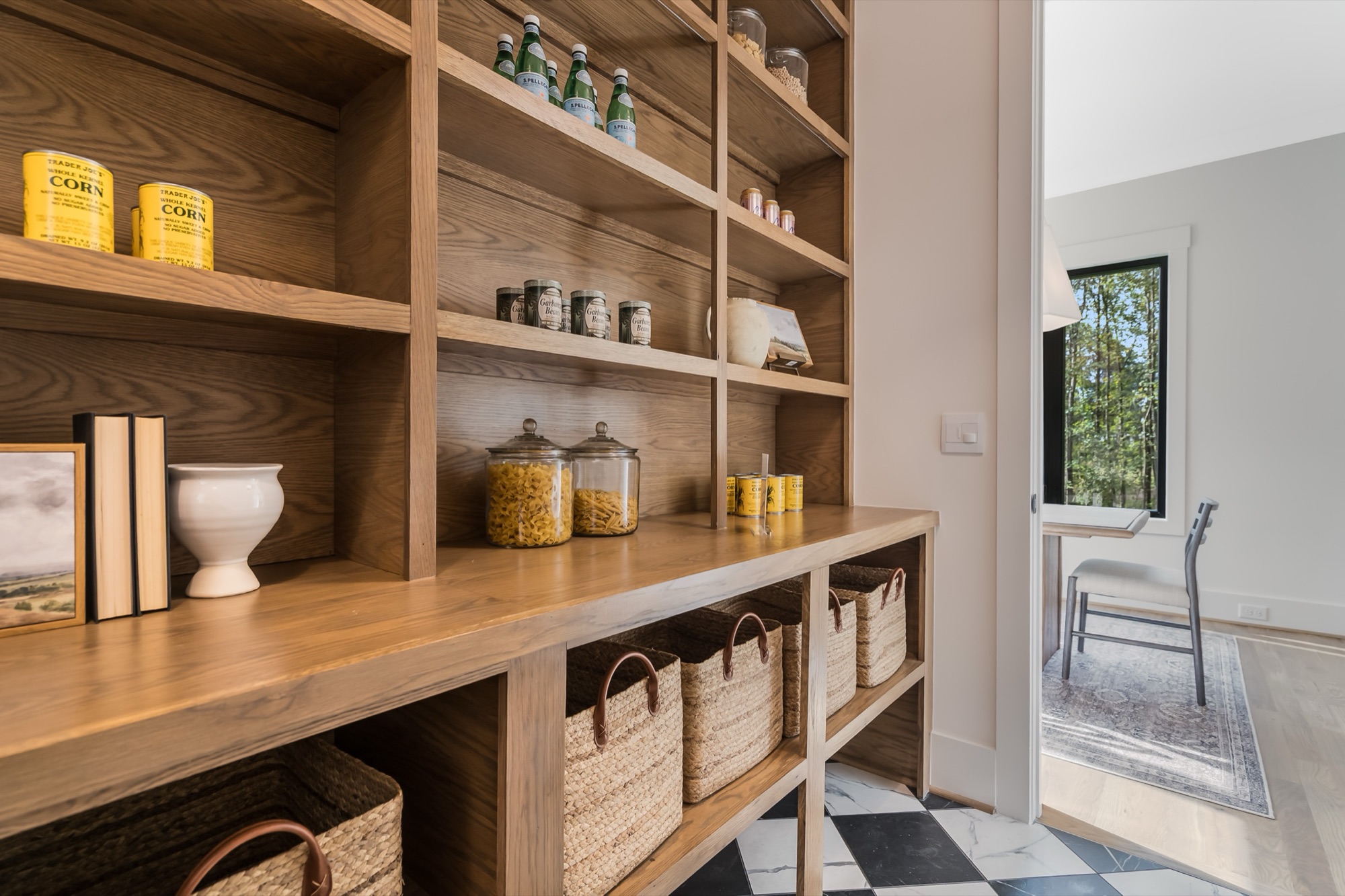 Built-in wooden pantry with styled jars and baskets